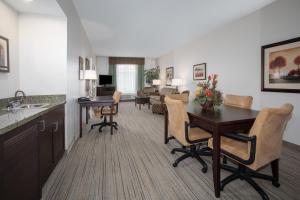 a kitchen and living room with a table and chairs at Holiday Inn Express & Suites Oro Valley-Tucson North by IHG in Oro Valley