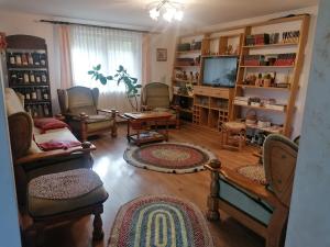 a living room filled with furniture and a tv at VoroLand in Gura Humorului