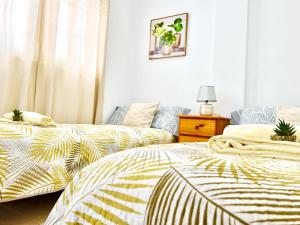 two beds sitting next to each other in a bedroom at !!! Relaxing View, The Heights Apartment With Terrace and Heated Pools, Los Cristianos in Los Cristianos