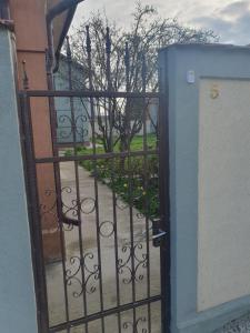 an open door with a gate with a garden behind it at Vila Sunset in Galaţi