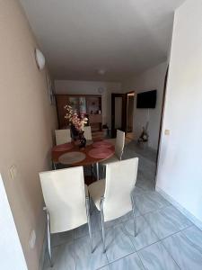 a dining room with a table and white chairs at Apartments Marina in Posedarje