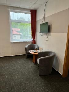 A television and/or entertainment centre at Penzión Michaela Vyhne