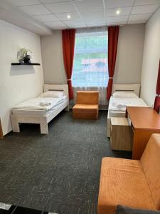 A bed or beds in a room at Penzión Michaela Vyhne