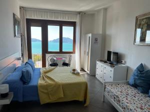 a bedroom with a blue bed and a window at B&B Camera Bellavista in Lerici