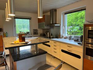 a large kitchen with a counter top and a sink at Haus Berger in Fuschl am See