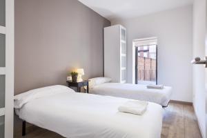 Posteľ alebo postele v izbe v ubytovaní Fira Apartments by gaiarooms