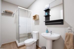 a bathroom with a toilet and a sink and a shower at Traditional Triana House with 9 en-suite Bedrooms in Las Palmas de Gran Canaria