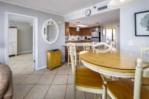 a kitchen and dining room with a table and chairs at Nautilus 1201 - Gulf Front 2 Bedroom Huge Wrap Around Balcony 2nd Floor! Free Beach Service 3/1-10/31 in Fort Walton Beach