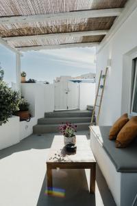 a living room with a couch and a table at Kalyva Cycladic house - Oia Santorini in Oia