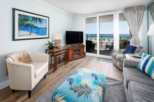 a living room with a couch and a television at Nautilus 1203 - Gulf Front 2 Bedroom! 2nd Floor! Free Beach Service March to October in Fort Walton Beach