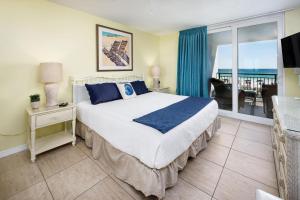 a bedroom with a bed and a view of the ocean at Nautilus 1203 - Gulf Front 2 Bedroom! 2nd Floor! Free Beach Service March to October in Fort Walton Beach +48 photos