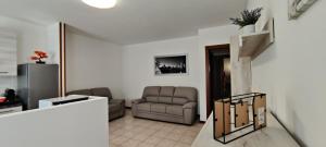 a living room with a couch and a chair at La casa Ciarlasca in Lacchiarella