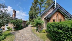 an old brick house with a clock tower on it at Am Rieck "Fachwerkaus" in Zempin