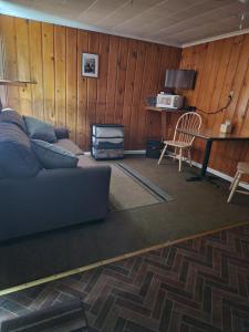 a living room with a couch and a table at Little River Motel Saint Regis in Saint Regis