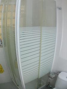 a glass shower in a bathroom with a toilet at Paseo de la Castellana in Madrid