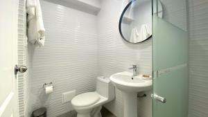 a bathroom with a toilet and a sink and a mirror at Classy 2BR in Miraflores in Lima