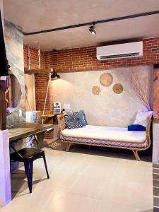 a living room with a bench in a brick wall at CLOCKWORKORANGE Luxury Suites in Mactan