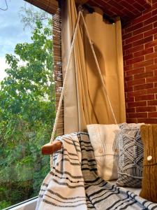 a porch swing in front of a window at CLOCKWORKORANGE Luxury Suites in Mactan