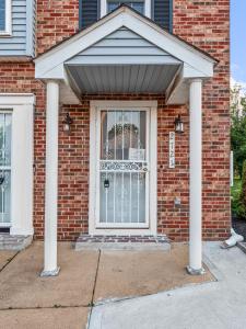 a front door of a brick house with two columns at VISTA A-A in Washington
