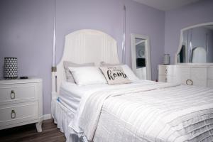a white bedroom with a white bed and a white dresser at VISTA A-A in Washington