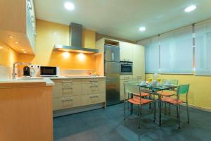 a kitchen with a glass table and chairs in it at Genteel Home Martinez Campos in Granada