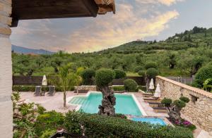 an outdoor swimming pool in a villa with a mountain at Art House Villa in Káto Yerakaríon