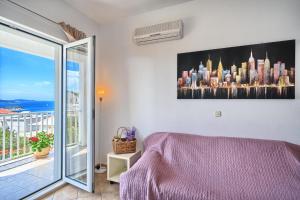 a bedroom with a purple bed and a balcony at Apartments Irena in Hvar