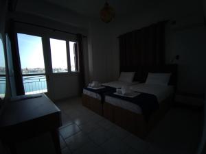 Ένα ή περισσότερα κρεβάτια σε δωμάτιο στο Omiros rooms