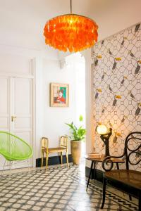 a room with chairs and a large orange light fixture at Genteel Home Romanilla in Granada