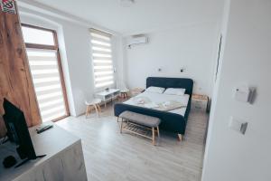a living room with a bed and a tv at Nestor Apartments in Bitola