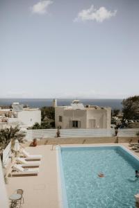 a swimming pool in front of a villa at Hotel Thirasia in Fira
