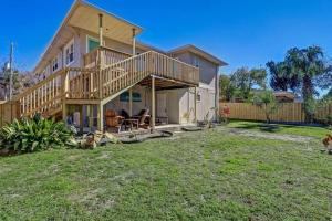 a large house with a deck on a yard at Beach Getaway at Jax Beach Studio Apartment in Jacksonville Beach