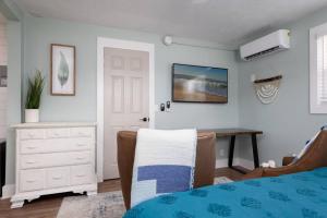 a bedroom with a bed and a desk and a dresser at Beach Getaway at Jax Beach Studio Apartment in Jacksonville Beach