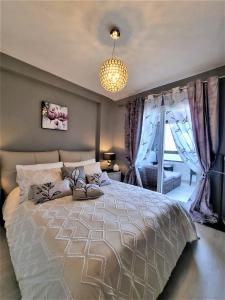 a bedroom with a large bed with purple curtains at Cabo Cervera primera linea apartamento de lujo in Torrevieja