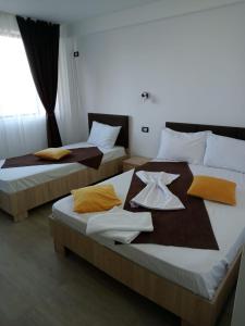 two beds in a hotel room with towels on them at Black Sea in Costinesti