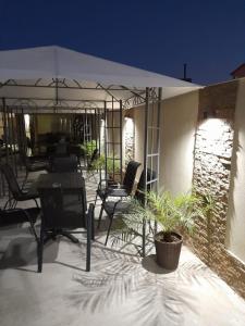 a patio with a table and chairs under a tent at Black Sea in Costinesti +4 photos