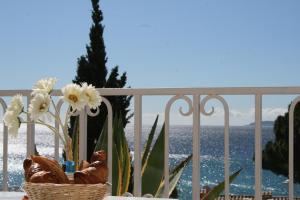 a basket of flowers sitting on a table on a balcony at Les Alcyons in Le Lavandou