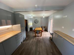 a kitchen with a table and a dining room at 10 Tarleton Avenue, Woodhall Spa in Woodhall Spa