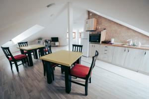 a kitchen with two tables and chairs in a room at Nestor Apartments in Bitola