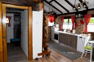 a kitchen with white appliances and a brick wall at Kuća za odmor Kristina in Novigrad Podravski