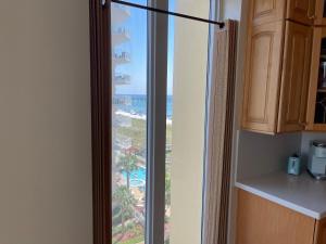 a kitchen with a sliding glass door with a view of the ocean at Caribbean Resort 501A - Link To The Beach in Navarre +10 photos