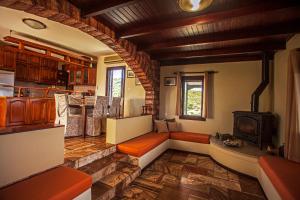 un salon avec une cheminée et un poêle dans l'établissement Villa Chloe - Amazing view Villa with swimming pool, à La Canée