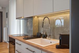 a kitchen with a sink and a counter top at City Base Apartment in Thessaloniki