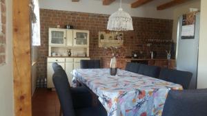 a dining room with a table with blue chairs at Dom na Warmii 