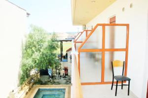 a balcony with a chair and a swimming pool at Erifili Kallithea in Kallithea Halkidikis