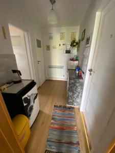 a hallway of a room with a kitchen and a rug at Agroturystyka Pod Lipą in Iwaniska