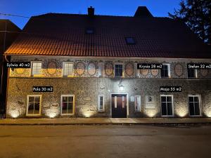 a building with signs on the side of it at night at Apartament Pola in Sokołowsko