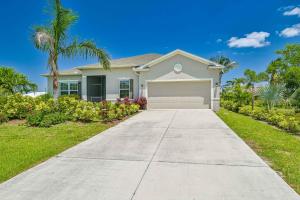 a house with a driveway in front of it at CHEERFUL VILLA 4 BEDROOM AND A HOT TUB in Cape Coral