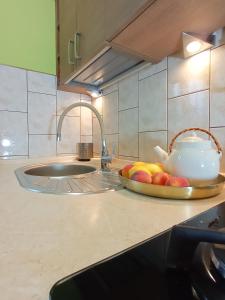 a kitchen counter with a bowl of fruit and a sink at Studio Art Deco - Starówka - Old Town - AZW Gdańsk in Gdańsk