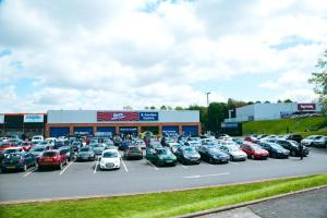 a parking lot full of cars in front of a store at White House in Netherton